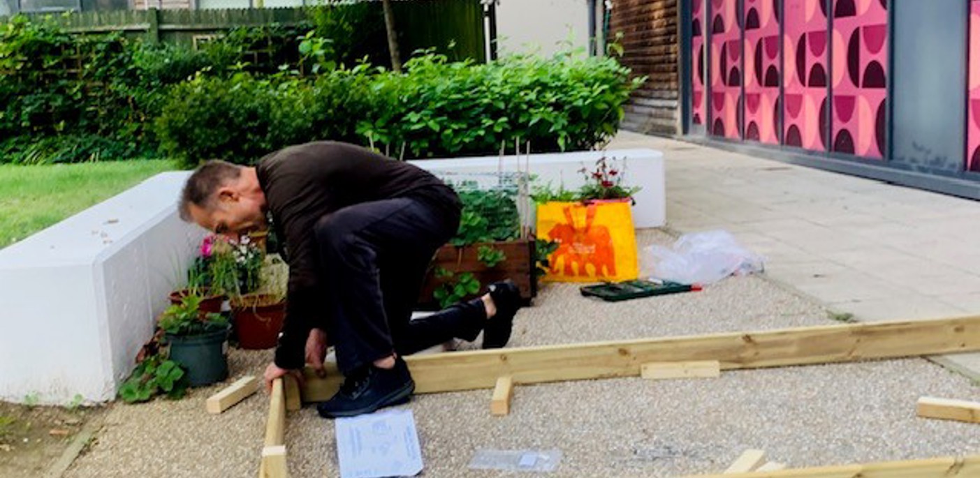 A colleague doing DIY in the garden at Factory Quarter