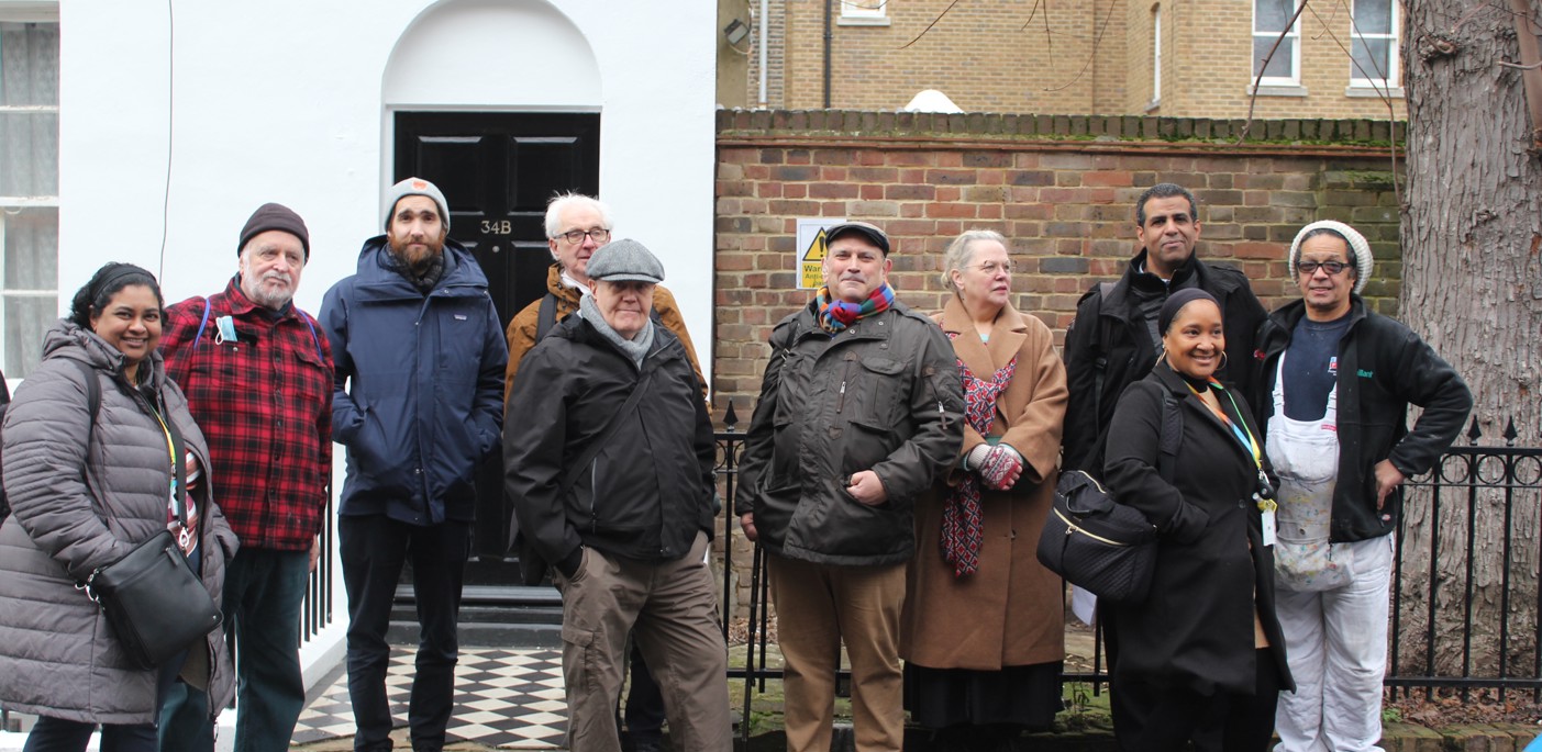 A group of residents standing on a street.