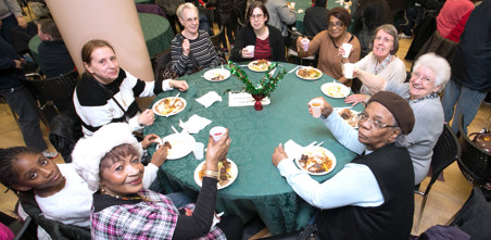 Residents round a table about to eat Christmas lunch