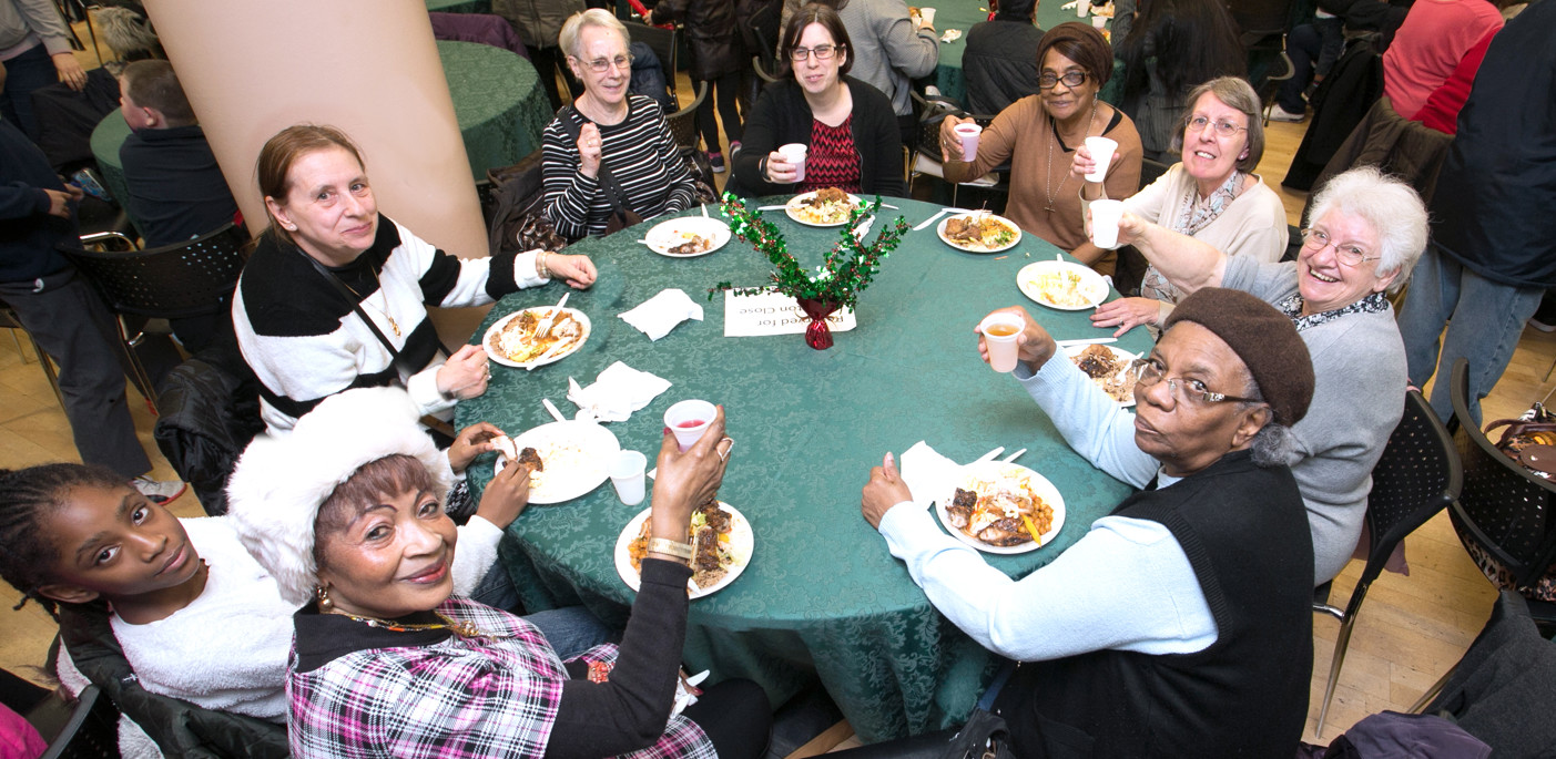 Residents round a table about to eat Christmas lunch
