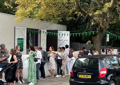 People queue to visit the building