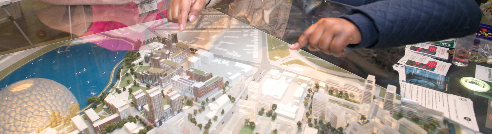 Families looking at a model of an estate.