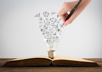 Person Drawing Symbols Coming Out Light Bulb Top Book
