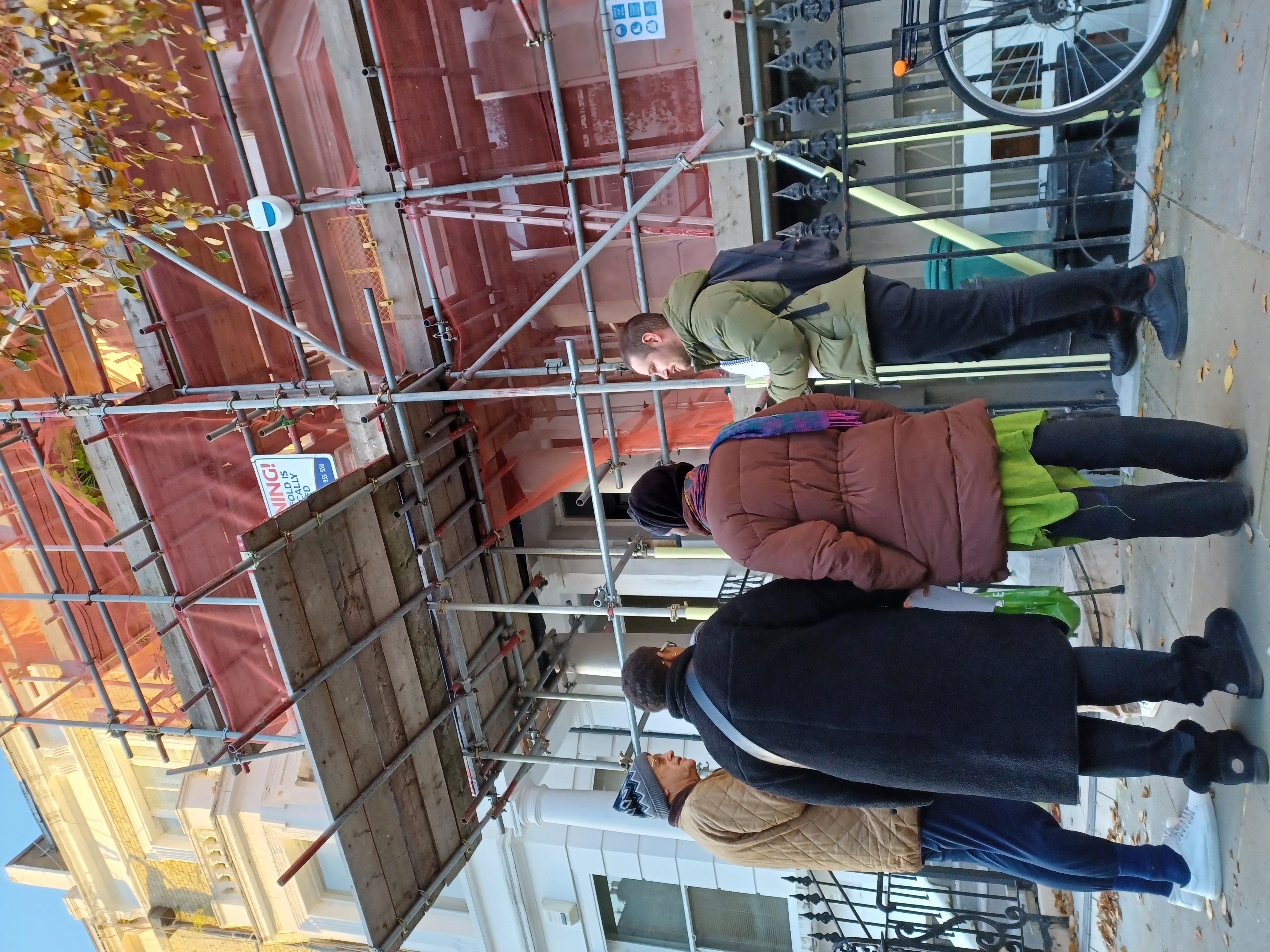 A group of residents standing on a street.