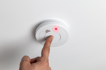 Testing home smoke alarm detector. Stay home safe. Home control and security. Smoke detector