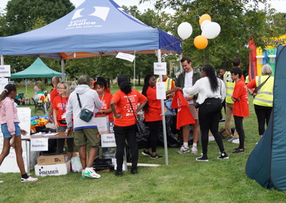Visitors at an information stand in a park.  