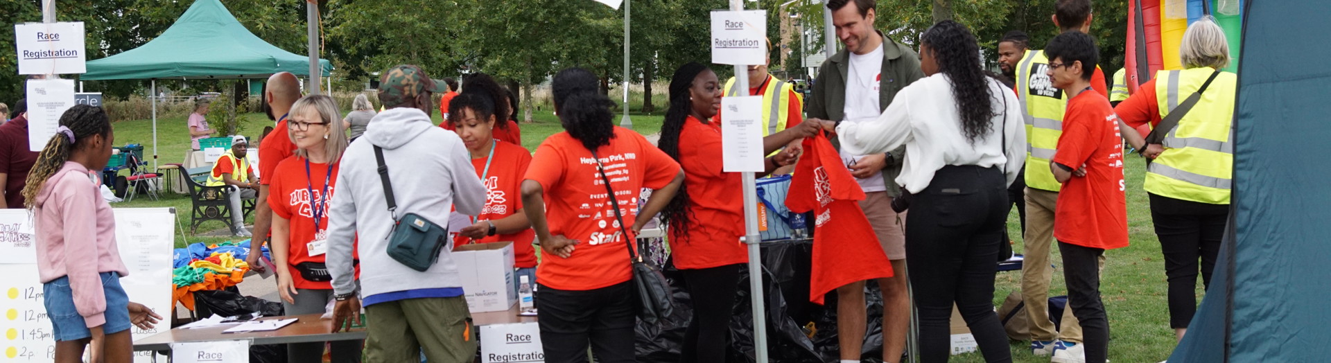 Visitors at an information stand in a park.  