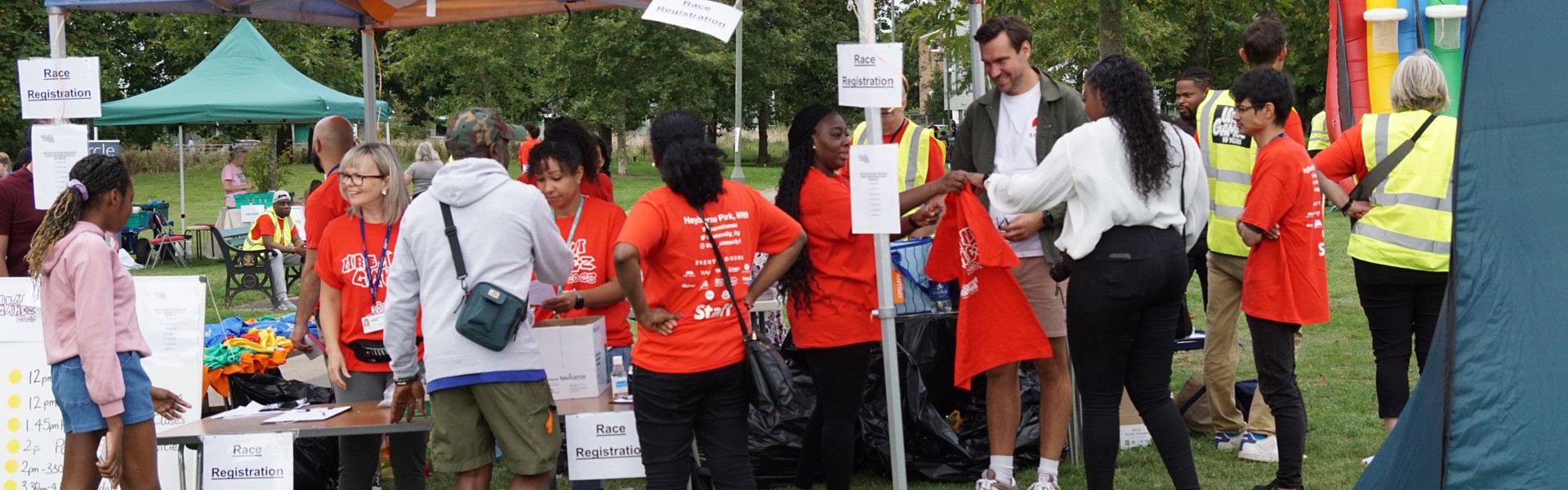 Visitors at an information stand in a park.  